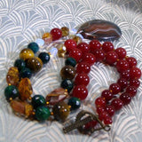 agate pendant on a necklace of gemstone beads