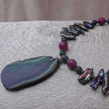 long bead statement necklace is bright peacock colours