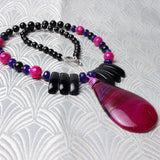pink agate gemstone pendant on black pink bead necklace
