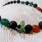 bright semi-precious stones in black neckalce