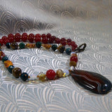 agate pendant on a necklace of semi-precious stone beads